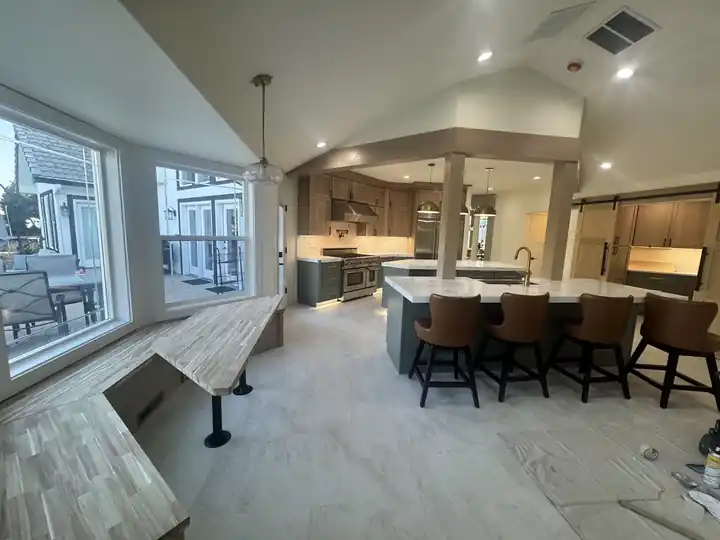 Open kitchen with new plank flooring going down during an install