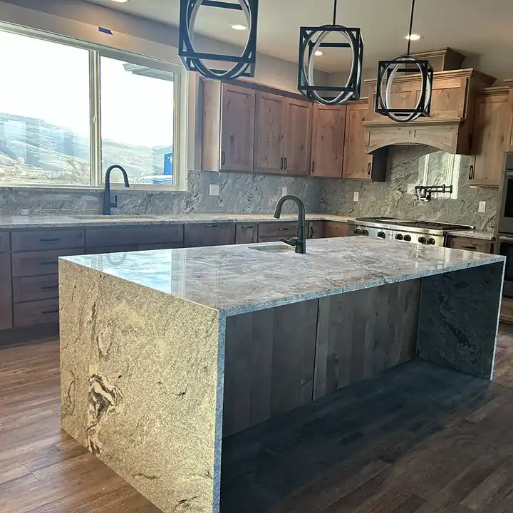 Granite waterfall island with matching stone sides in a Yakima kitchen
