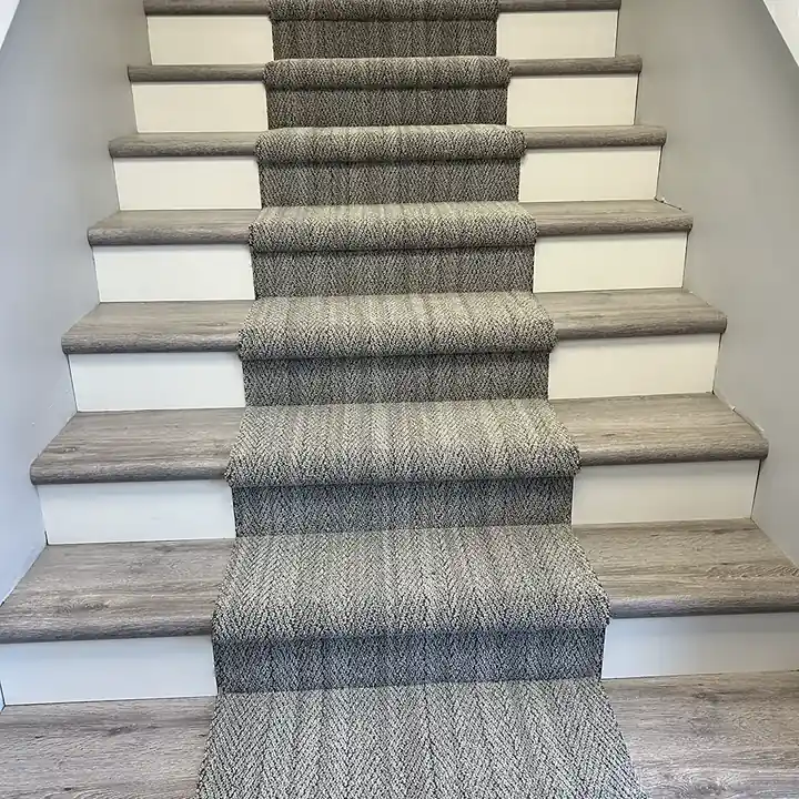 Herringbone carpet runner installed down a staircase